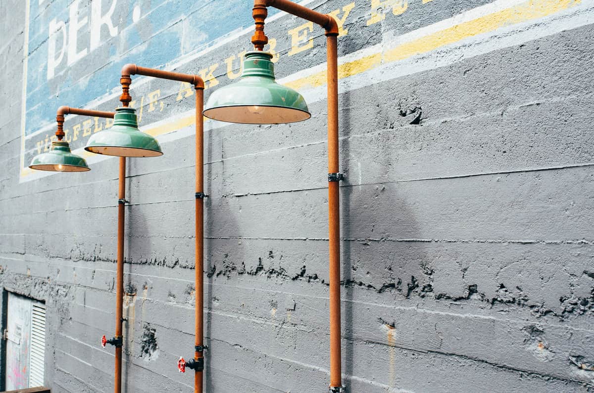 Copper pipework running along a light wall